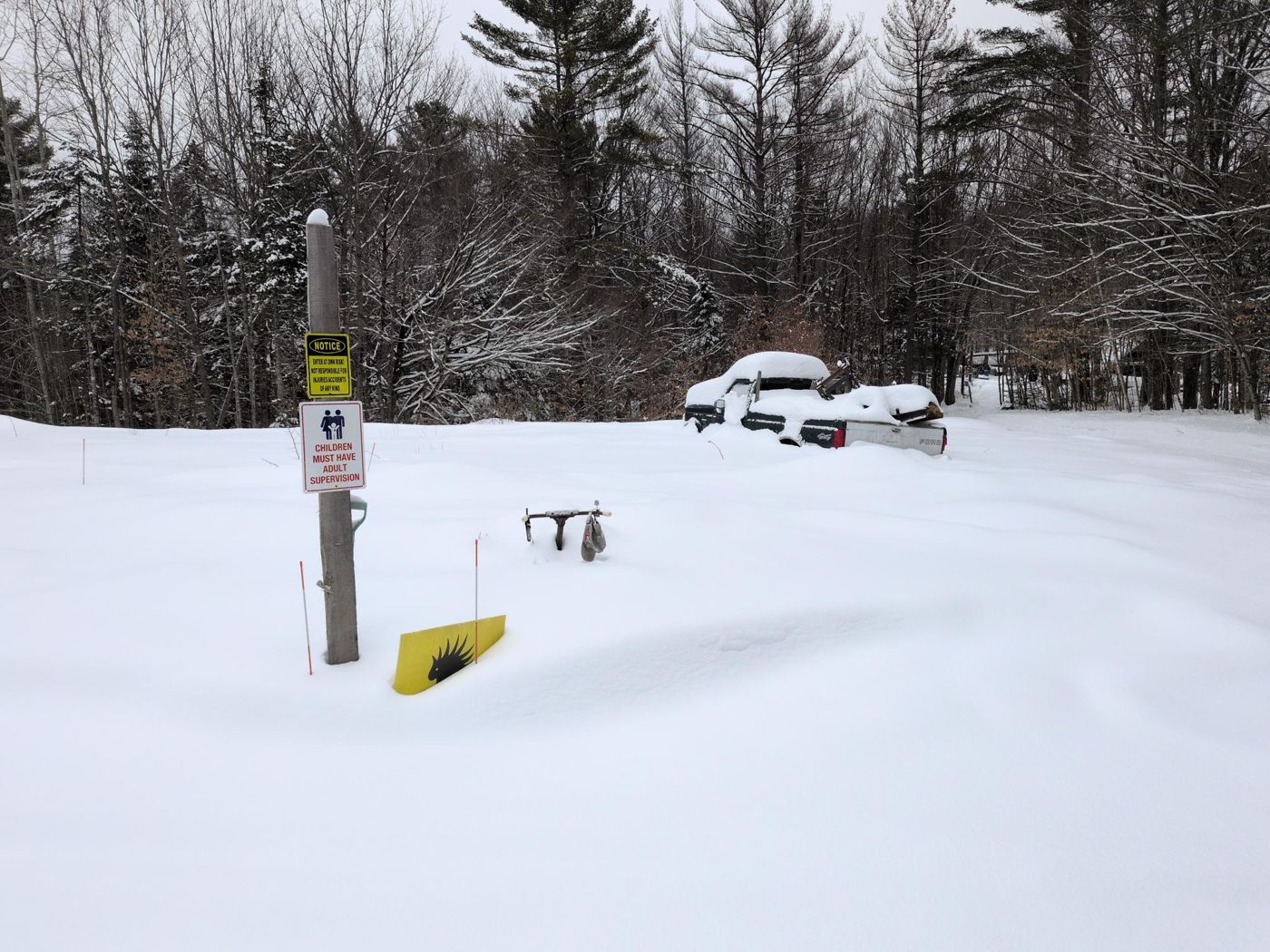 camp sign post and vehicles in snow at Bartertowne, Canaan New Hampshire
