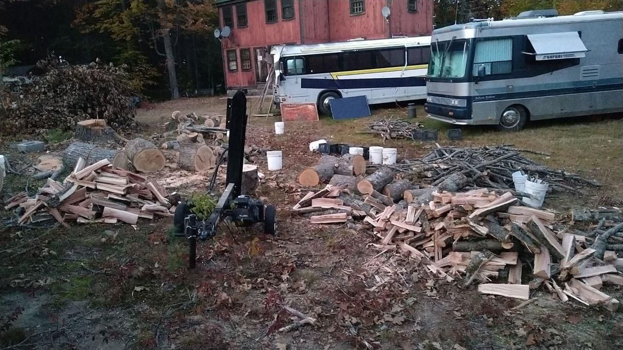 firewood pile and converted bus camp at Bartertowne, Canaan New Hampshire
