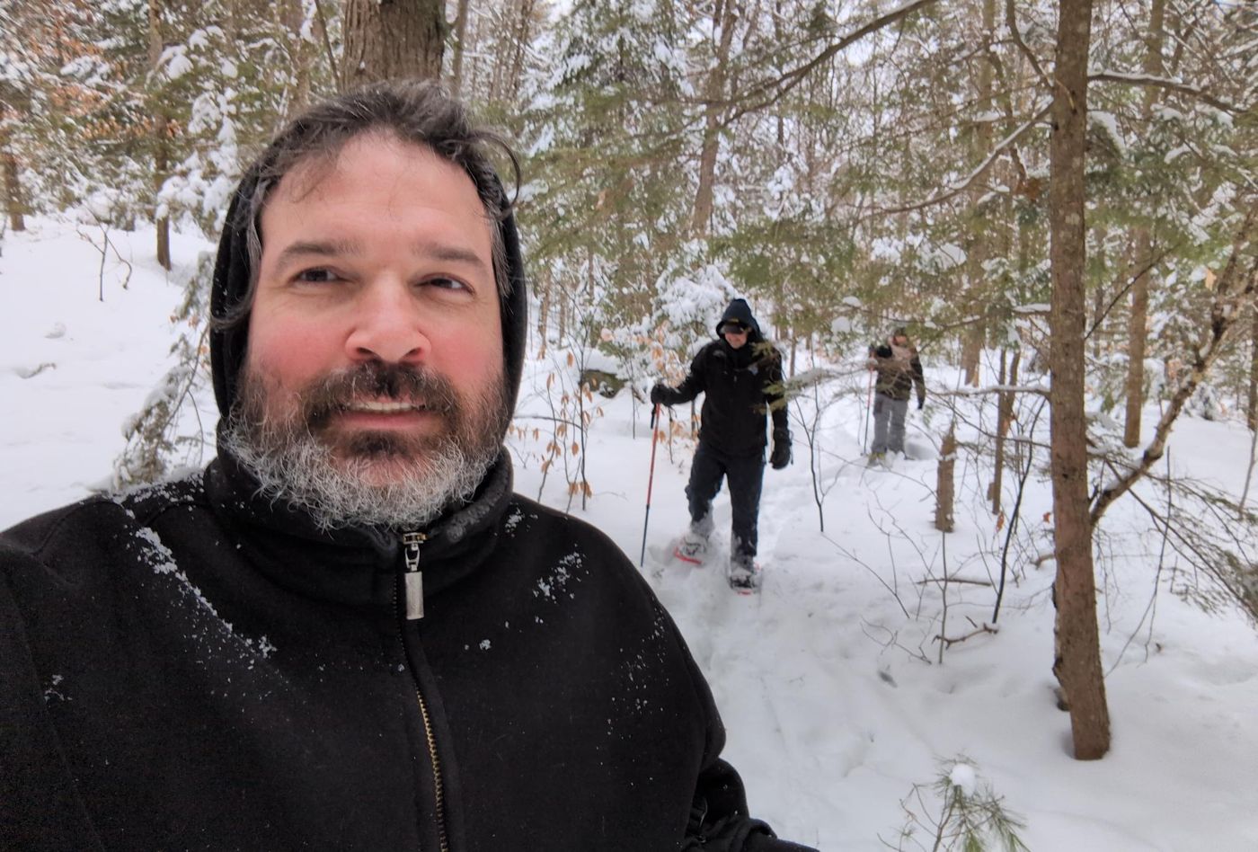 snowy woodland trail among bare trees at Bartertowne, Canaan New Hampshire